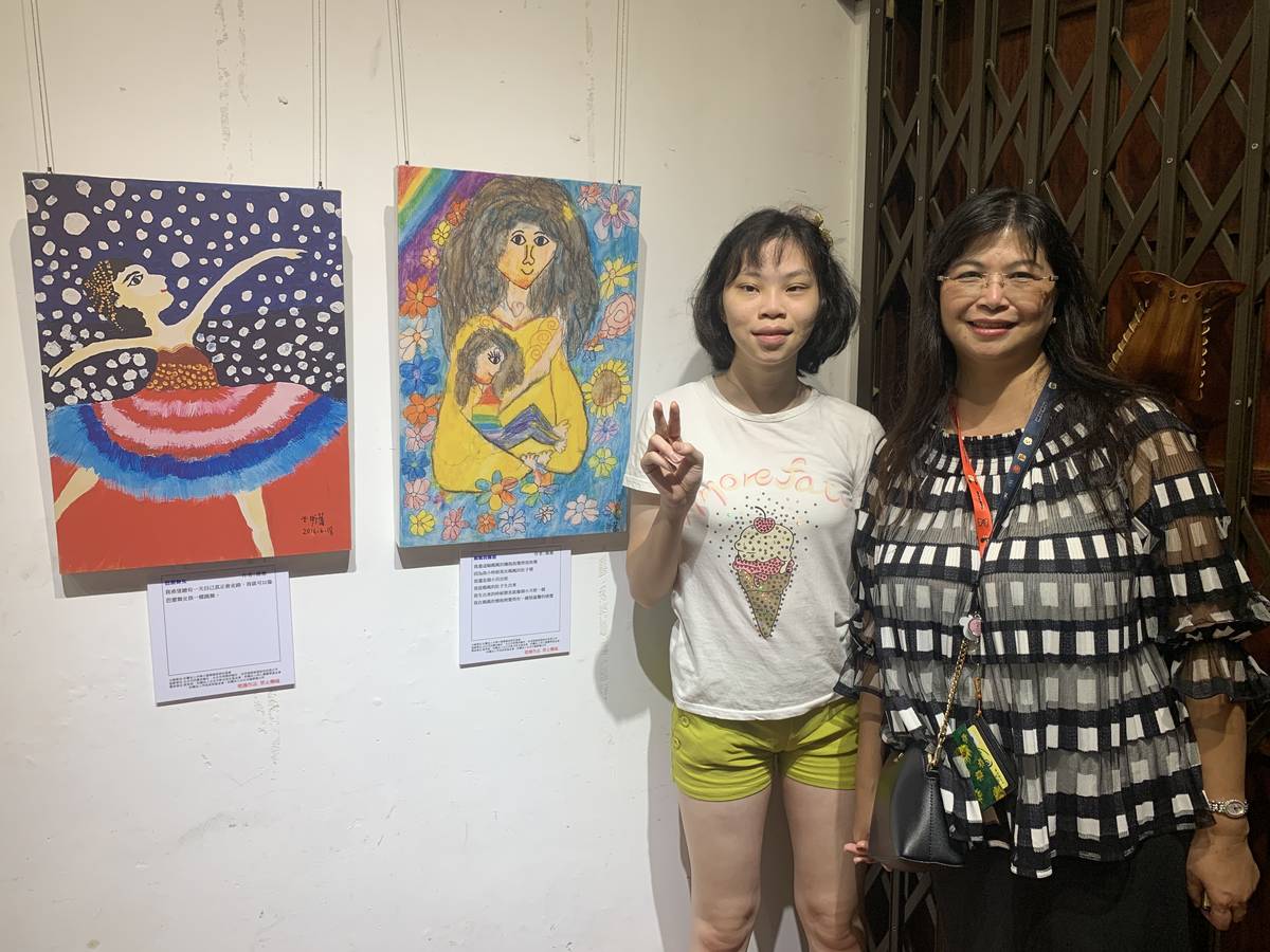 罕見天使蕎蕎、蕎蕎媽媽與她的作品合影。