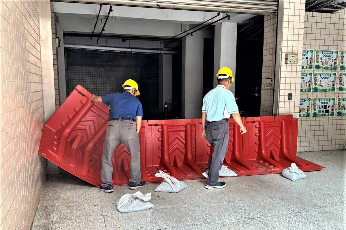 學校派員至地下室入口放置擋水板及沙包，預防積水流入