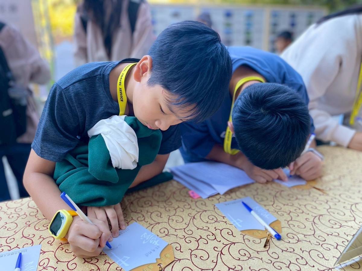 競賽員報到後在許願祈福區寫祈願卡 (教育部提供)