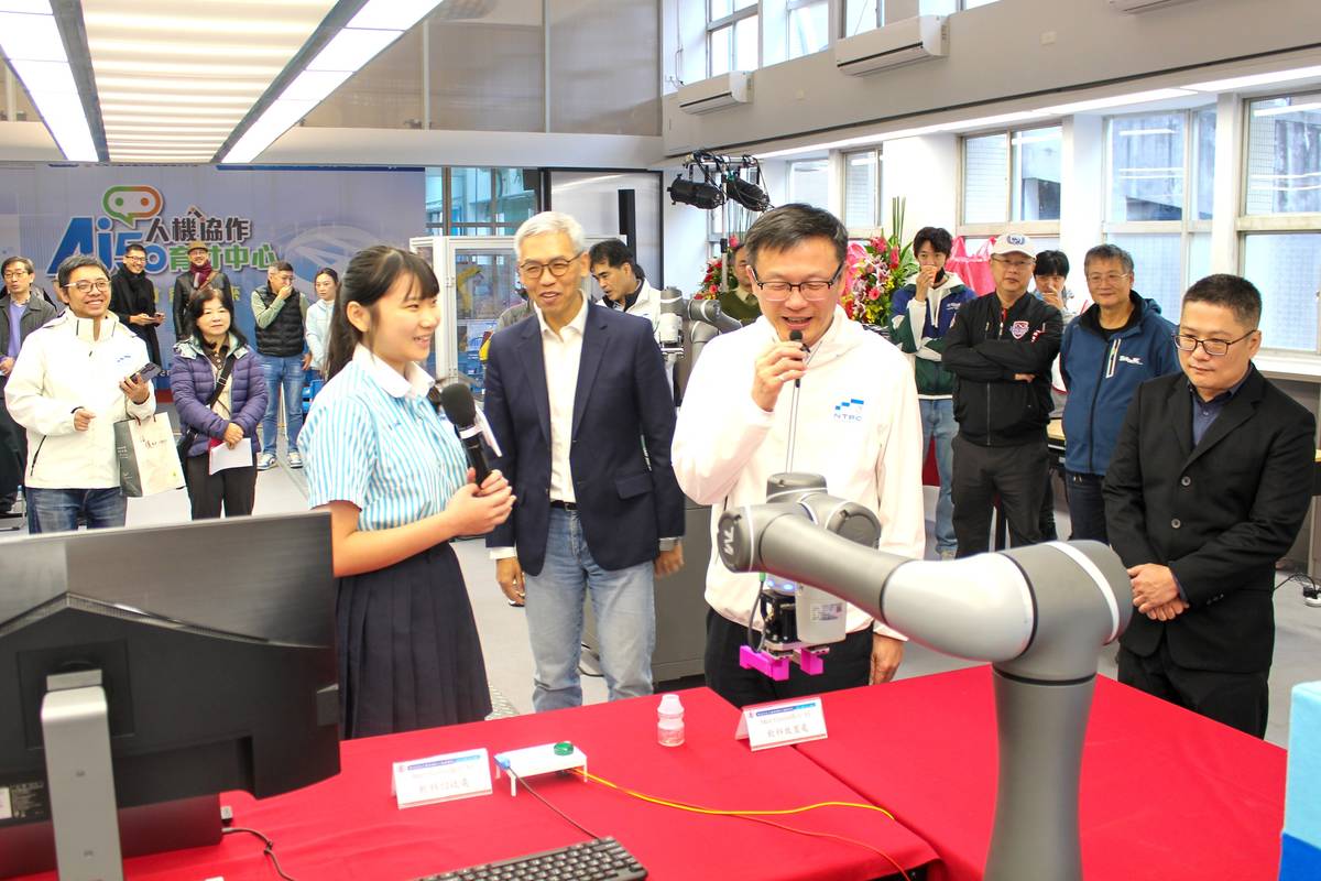 三重商工機械科三年級黃盈蓁同學陪同局長進行智慧型機器手臂運作